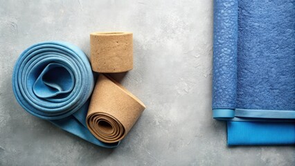Aufkleber - A close-up of rolled-up fabric, showcasing different textures and shades of blue and brown