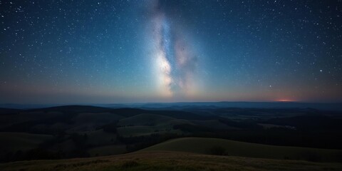 Wall Mural - a vast expanse of starry night sky over a serene landscape with rolling hills and trees scattered ac