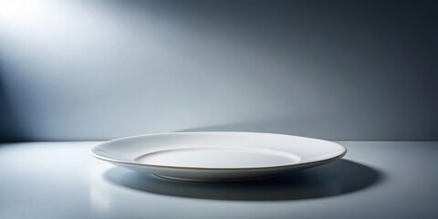 Poster - A Single White Plate Rests on a Blue Surface Against a Neutral Background, Creating a Simple and Minimalist Setting for Displaying Culinary Creations