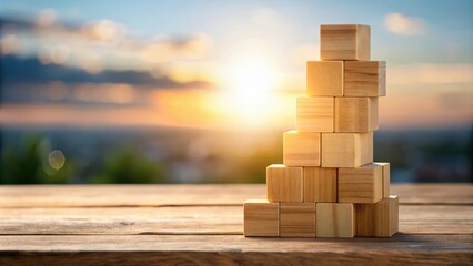 Aufkleber - Wooden Blocks Stacked in a Pyramid Shape Against a Blurred Sunset Background