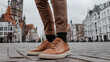 © kvladimirv - Fashionable Man in Brown Sneakers and Trousers Exploring a European Urban Street
