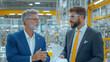 © niwat - Senior businessman having discussion with colleague in factory