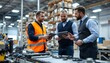 © Nelson - Engineers using digital tablets and discussing work in factory