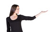 © peshkova - Smiling woman inlong-sleeve top pointing or presenting with an extended hand, isolated on a clean white background. Concept of presentation