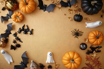 Wall Mural - Halloween holiday frame with party decorations of pumpkins, bats, ghosts, spiders on golden background top view. Happy halloween greeting card in flat lay style.