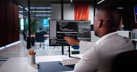 Fototapete - African American Coder Using Computer At Desk