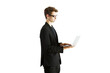 © peshkova - A man in a blazer using a laptop while standing in side profile. Isolated on a white background. Concept of business, technology, and productivity
