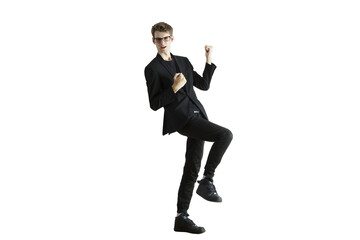 Poster - Man in a dynamic celebratory pose wearing asuit and glasses, standing on one leg, isolated on a white background, concept of success
