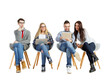 © peshkova - Four young adults sitting on modern chairs, using a laptop and tablet. Casual attire, white background. Concept of teamwork and collaboration