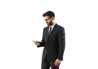 Poster - A man in a formal suit and tie holding and looking at a smartphone, standing on a white background. Professional and business concept