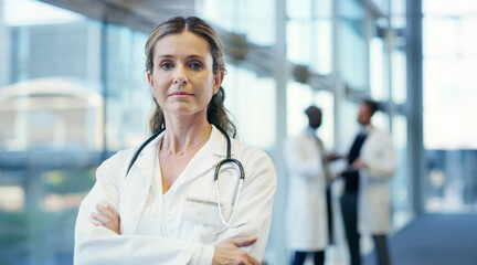Poster - Woman, doctor and portrait with confidence for medical service, healthcare career or job at hospital. Female person, health professional or cardiologist with stethoscope or arms crossed at clinic