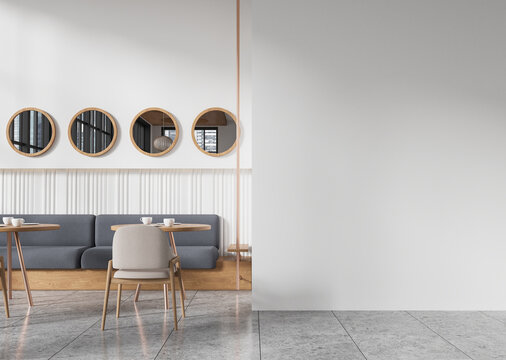 Modern cafe interior with minimalistic design and blank white wall for mockup or copy space. 3D Rendering