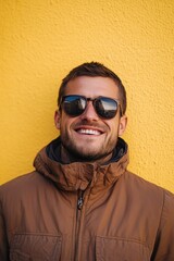 Poster - A person wearing shades stands in front of a bright yellow surface