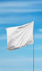 Poster - White blank flag against a clear sky, vertical composition, perfect for mockup designs, branding promotions, or showcasing customizable flags for creative projects