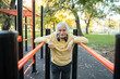 © Marko Geber - Portrait of a senior man exercising at outdoor fitness park in autumn