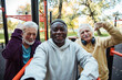 © Marko Geber - Senior friends taking a selfie after a group workout at an outdoor park