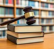 © 海翰 章 - Wooden gavel on a library table surrounded by bookshelves, symbolizing law, justice, and intellectual rights, ideal for legal and academic concepts.