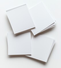 Poster - A stack of blank white paper sheets arranged casually on a light background, perfect for mockups, design projects, or artistic creations.