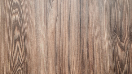 Poster - A wooden surface with a grain pattern. The wood is brown and has a natural texture. The surface is smooth and has no visible blemishes