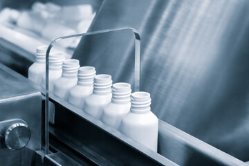 Poster - White plastic bottles for medicines and vaccines in a pharmaceutical factory