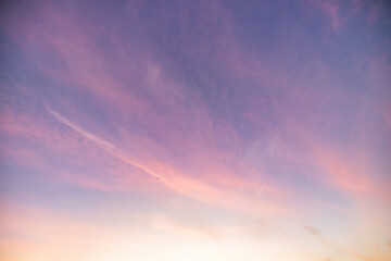 Wall Mural - a beautiful sky tinted by the sun leaving vibrant shades of gold, pink, blue and multicolored. cloud