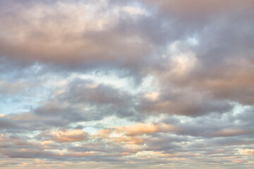 Wall Mural - a beautiful sky tinted by the sun leaving vibrant shades of gold, pink, blue and multicolored. cloud
