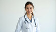 © Imagehub - A smiling female doctor in a white coat and stethoscope  exuding confidence and professionalism.