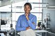 © insta_photos - Happy confident young professional business woman ceo corporate leader, smiling female African American businesswoman lawyer or hr manager wearing blue shirt standing in office, portrait.