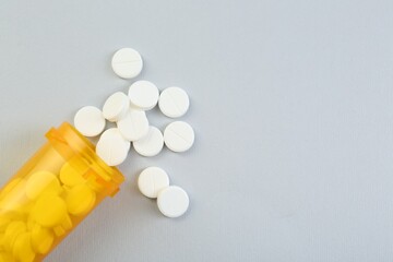 Wall Mural - Antibiotic pills and medical bottle on grey background, top view. Space for text