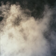 Wall Mural - A swirling cloud of smoke against a dark background, creating an atmospheric effect.