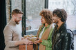 © lithiumphoto - A multi ethnic group of friends giving each other gifts