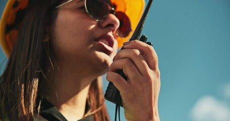 Poster - Engineering, woman and talking on radio outdoor for inspection update, project management and maintenance. Contractor, person or speaking on device for safety check or feedback on property renovation