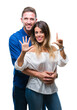 © Krakenimages.com - Young couple in love over isolated background showing and pointing up with fingers number seven while smiling confident and happy.