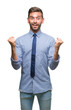 © Krakenimages.com - Young handsome business man over isolated background celebrating surprised and amazed for success with arms raised and open eyes. Winner concept.