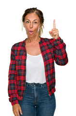 Canvas Print - Middle age adult woman wearing casual jacket over isolated background pointing finger up with successful idea. Exited and happy. Number one.