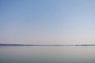 Wall Mural - lake with birds and boats out of focus. minimalism. misty early morning in the sea. calm view. tranq