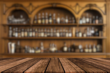 Empty wooden bar counter with defocused background and bottles of restaurant, bar or cafeteria background for your product display