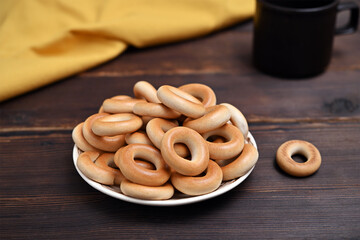 plate with bagels on wooden background