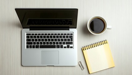 Poster - A workspace setup featuring a laptop, coffee cup, notepad, and paperclip, ideal for productivity.
