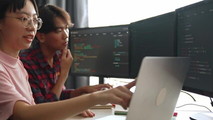 Slow motion back end software developer engineer for computer programming working together on debugging writing computing code, solving complex algorithms display on monitor in office. Burgeoning