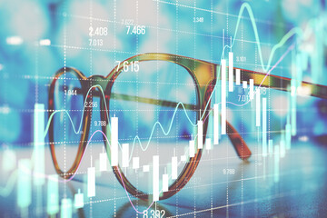 Canvas Print - Financial charts and graphs overlay on glasses with blue background.