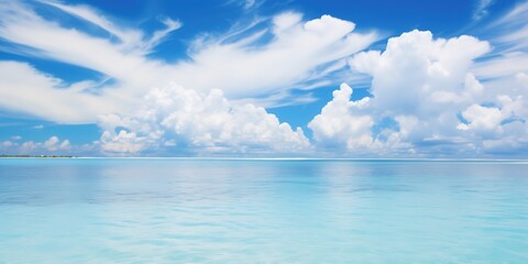  A beautiful blue ocean with a few clouds in the sky