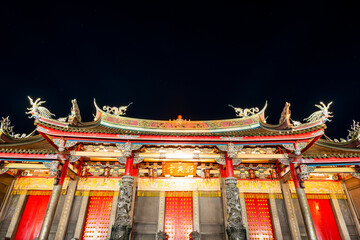 Wall Mural - Night view of Xingtian Temple building in Taipei, Taiwan. The temple is devoted to Lord Guan. In 2014, it's became the first in Taiwan to ban the burning of incense.