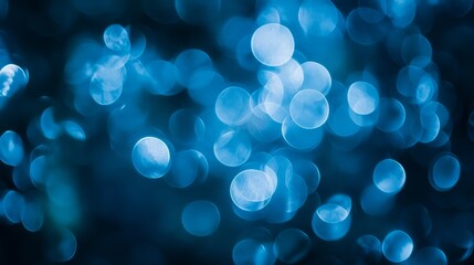 Abstract bokeh effect with soft circles of light in cool blue tones, blurred and dreamy