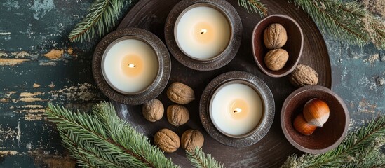 Aufkleber - Holiday candles surrounded by fir branches and assorted nuts on a rustic table setting for festive ambiance and seasonal decoration.