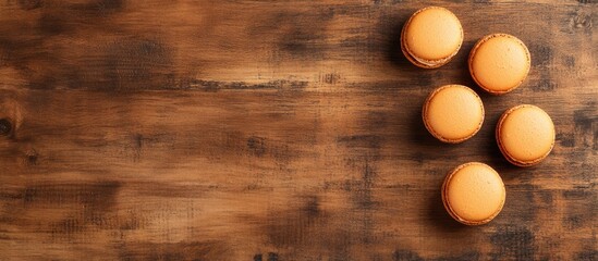 Poster - Deliciously arranged macarons on a rustic wooden background showcasing tasty desserts with ample negative space for design versatility