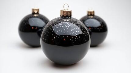 Poster - Elegant black Christmas ornaments with gold accents on a soft white background for festive holiday decor themes.