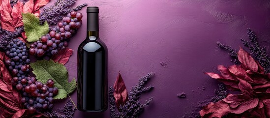Poster - Red wine bottle mockup on purple background with empty glass and foliage suitable for label design and promotional text area aerial view