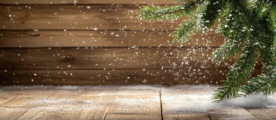Poster - Christmas decorations with fir tree branch on rustic wooden surface and blurred sparkling snow creating a festive winter atmosphere