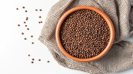 Aufkleber - Bowl filled with raw black beans atop textured fabric on a white background showcasing natural food ingredients for culinary use